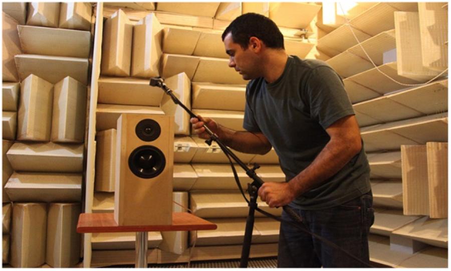 Photo of the designer doing measurements on the kit in anechoic chamber